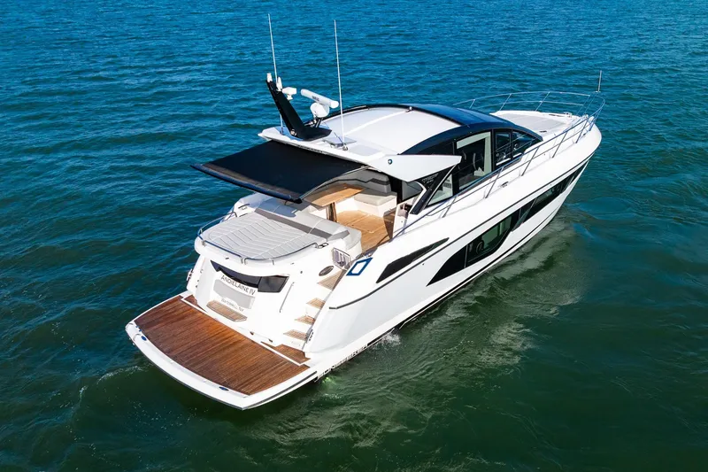 Slide: The Image of 2021 Sunseeker 60 Evo yacht cruising on open water, rear view. - 11