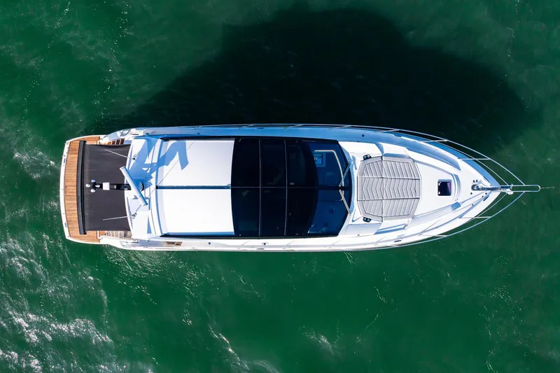 Slide: The Image of Aerial view of 2021 Sunseeker 60 Evo yacht on green water. - 12