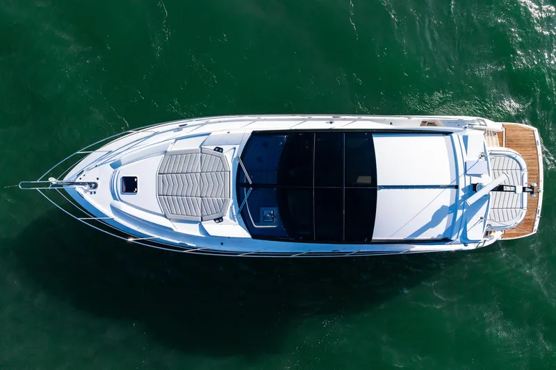Slide: The Image of Overhead view of 2021 Sunseeker 60 Evo yacht on green water. - 13