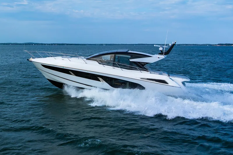 Slide: The Image of 2021 Sunseeker 60 Evo yacht cruising on open water, showcasing sleek design and luxury. - 17