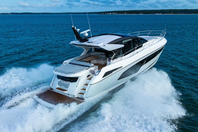 Slide: The Image of 2021 Sunseeker 60 Evo yacht cruising on open water, rear view. - 21