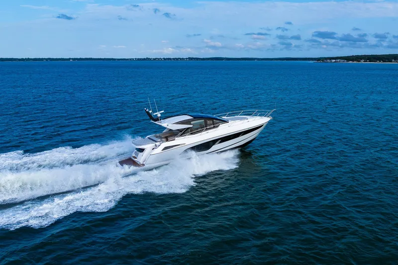 Slide: The Image of 2021 Sunseeker 60 Evo yacht cruising on open blue sea. - 22