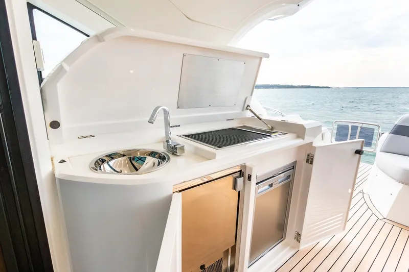 Slide: The Image of Outdoor kitchen on 2021 Sunseeker 60 Evo yacht with sink and grill by the sea. - 38