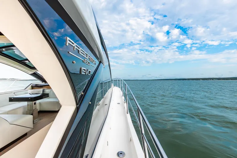 Slide: The Image of Luxurious 2021 Sunseeker 60 Evo yacht cruising on open water under blue sky. - 40