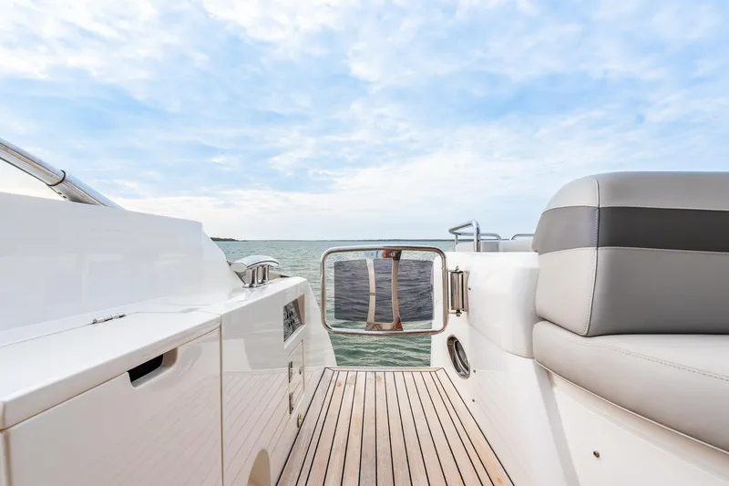 Slide: The Image of Sunseeker 60 Evo 2021 yacht deck with ocean view and seating area. - 45
