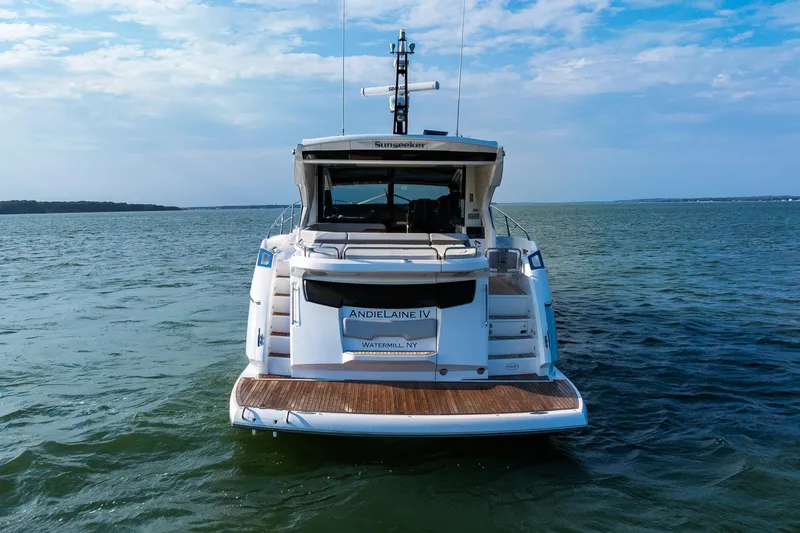 Slide: The Image of 2021 Sunseeker 60 Evo yacht on open water, rear view. - 5