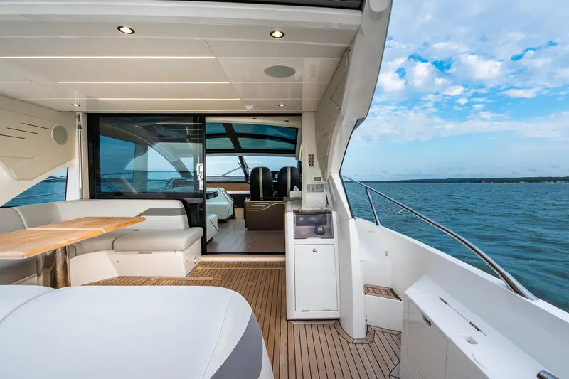 Slide: The Image of Luxurious 2021 Sunseeker 60 Evo yacht interior with ocean view and elegant seating area. - 53