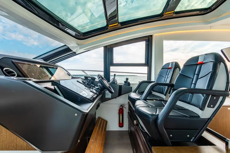 Slide: The Image of Luxurious 2021 Sunseeker 60 Evo yacht cockpit with leather seats and modern controls. - 65