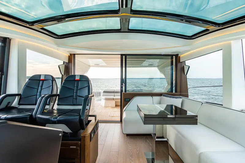 Slide: The Image of Luxurious interior of 2021 Sunseeker 60 Evo yacht with panoramic windows and elegant seating. - 67