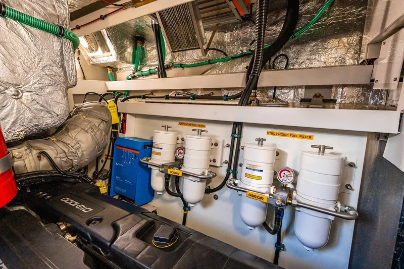 Slide: The Image of Engine room of 2021 Sunseeker 60 Evo yacht with fuel filters and mechanical components. - 77