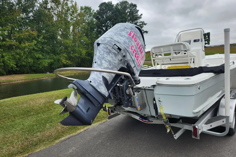 Slide: The Image of 2019 BlackJack 224 boat with Yamaha engine on trailer by a lake. - 3