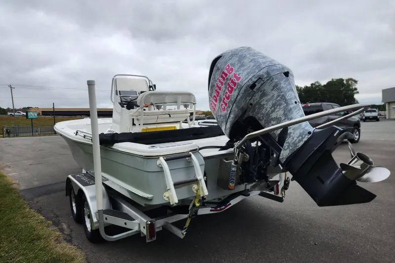 Slide: The Image of 2019 BlackJack 224 boat with Yamaha outboard motor on a trailer, parked outdoors. - 4