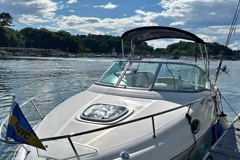 The Image of 2009 Sea Ray 230 Sundancer boat on a scenic lake with clear skies. - 0