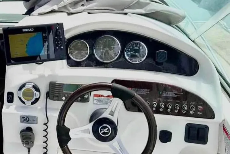 Slide: The Image of Dashboard of a 2009 Sea Ray 230 Sundancer boat with navigation equipment. - 3