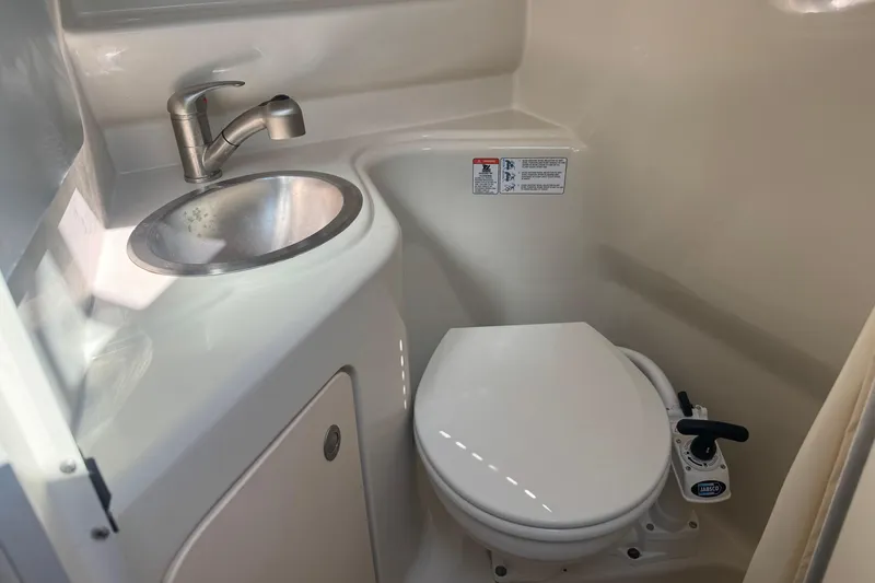 Slide: The Image of 2009 Sea Ray 230 Sundancer boat bathroom with sink and toilet. - 7