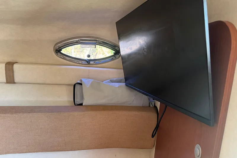 Slide: The Image of Interior of 2009 Sea Ray 230 Sundancer with TV and porthole window. - 8