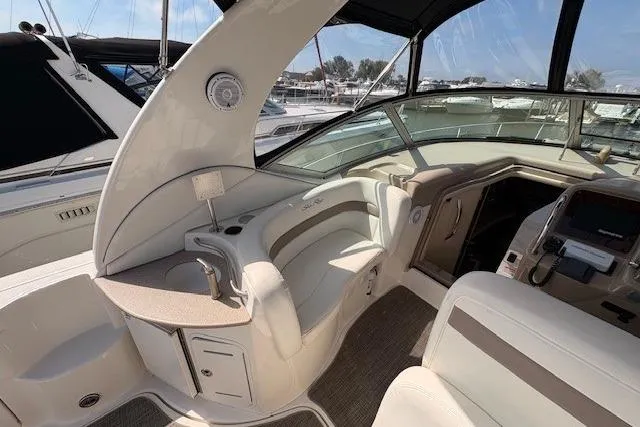 Slide: The Image of 2004 Sea Ray 320 Sundancer boat interior with helm and seating area. - 10