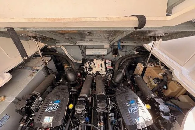 Slide: The Image of Engine compartment of a 2004 Sea Ray 320 Sundancer boat, showcasing dual engines. - 11