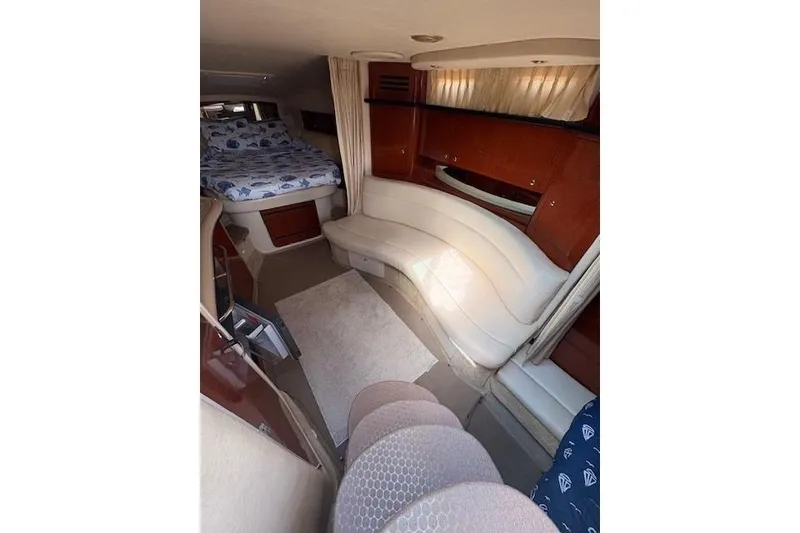 Slide: The Image of Interior of 2004 Sea Ray 320 Sundancer with cozy seating and bed area. - 12