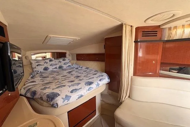 Slide: The Image of Interior of 2004 Sea Ray 320 Sundancer with cozy bed and elegant wood finish. - 14