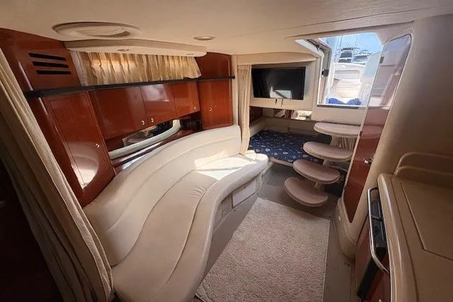 Slide: The Image of Interior of 2004 Sea Ray 320 Sundancer yacht with elegant seating and wooden cabinetry. - 17