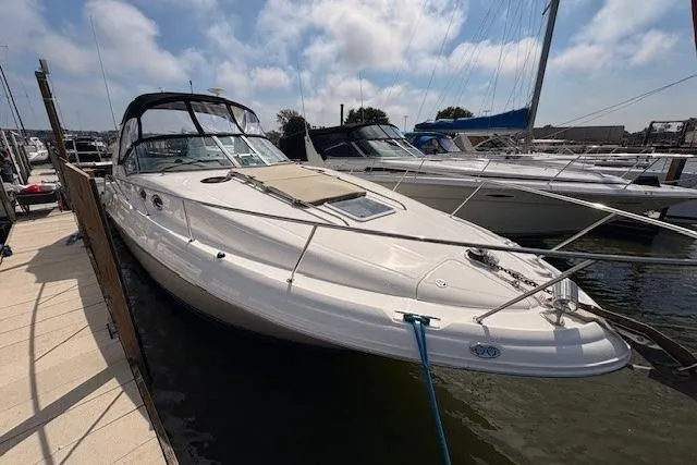 Slide: The Image of 2004 Sea Ray 320 Sundancer docked at marina under cloudy sky. - 3