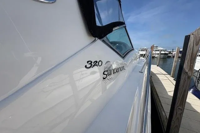 Slide: The Image of 2004 Sea Ray 320 Sundancer docked at marina under clear blue sky. - 4