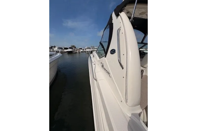 Slide: The Image of 2004 Sea Ray 320 Sundancer docked at marina under clear blue sky. - 5