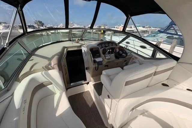 Slide: The Image of Interior view of 2004 Sea Ray 320 Sundancer yacht with helm and seating area. - 6