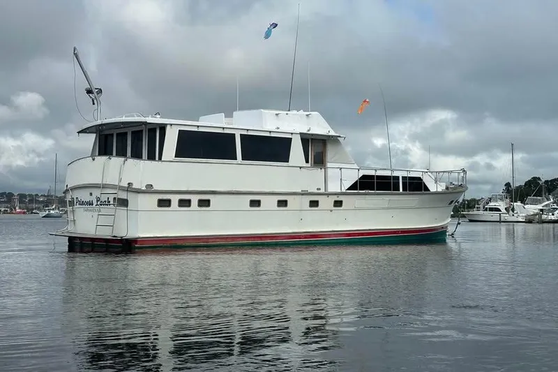 The Image of 1975 Pacemaker 62 Motor Yacht on calm water, overcast sky background. - 1