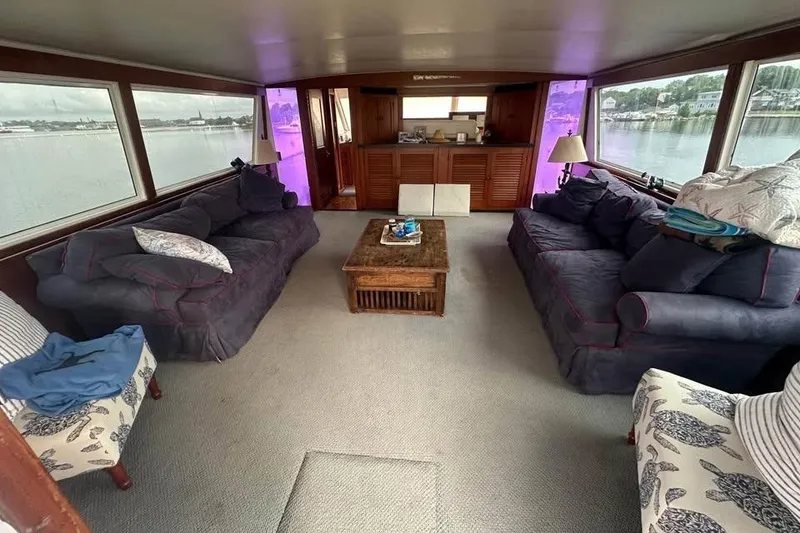 Slide: The Image of Interior of 1975 Pacemaker 62 Motor Yacht with cozy seating and panoramic windows. - 3