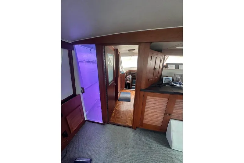 Slide: The Image of Interior of 1975 Pacemaker 62 Motor Yacht with wooden cabinetry and carpeted flooring. - 6