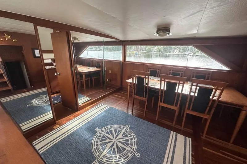Slide: The Image of Interior of 1975 Pacemaker 62 Motor Yacht with dining area and nautical-themed decor. - 8
