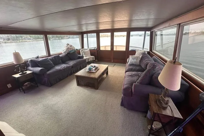 Slide: The Image of Interior of 1975 Pacemaker 62 Motor Yacht with cozy seating and waterfront views. - 9