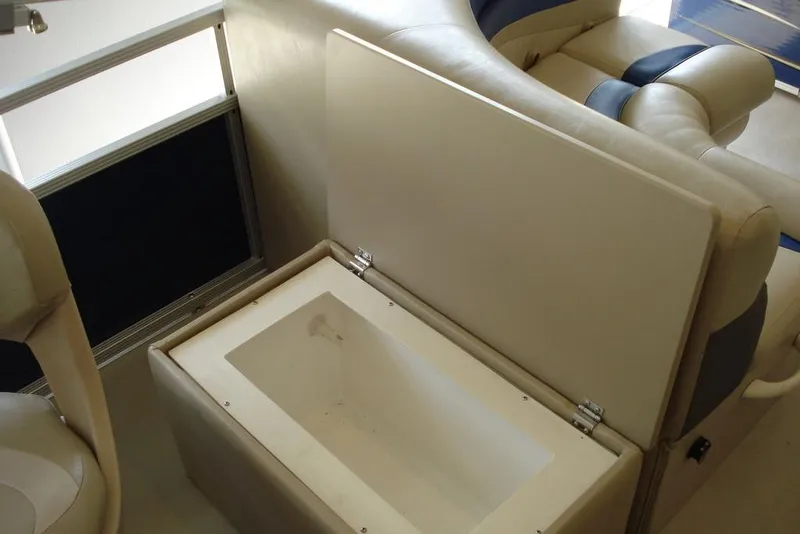 Slide: The Image of 2013 Manitou Aurora 22 VP boat interior with open storage compartment. - 8