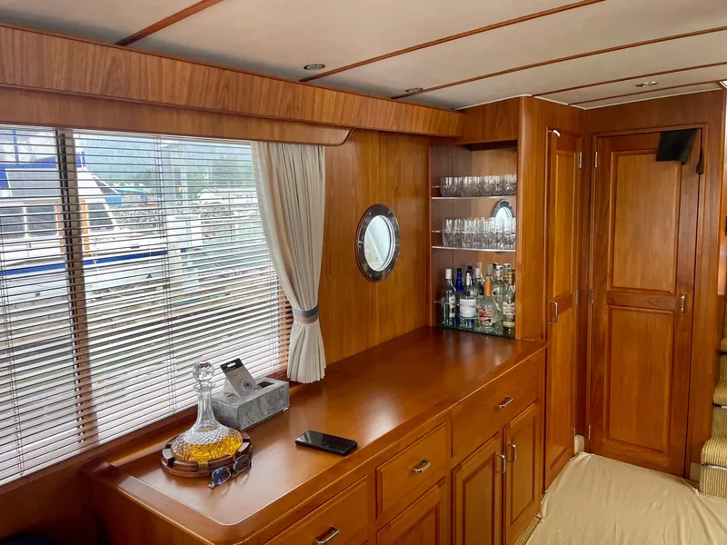 Slide: The Image of 1987 Tollycraft Pilothouse Motor Yacht interior with wooden cabinetry and bar setup. - 12