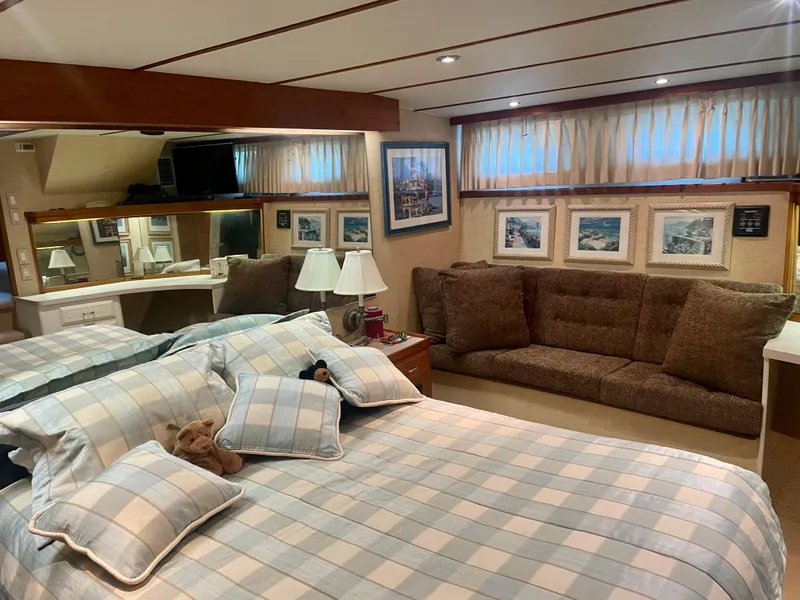 Slide: The Image of 1987 Tollycraft Pilothouse Motor Yacht bedroom with plaid bedding, sofa, and framed artwork. - 14