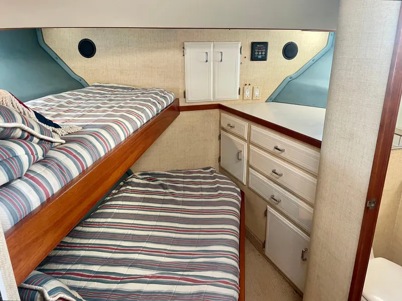 Slide: The Image of 1987 Tollycraft Pilothouse Motor Yacht cabin with bunk beds and storage drawers. - 22