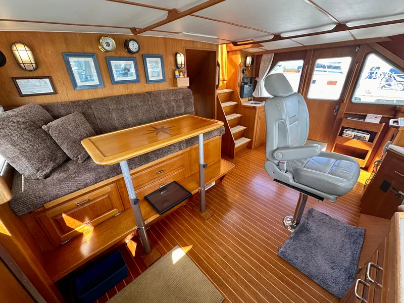 Slide: The Image of 1987 Tollycraft Pilothouse Motor Yacht interior with wood accents and captain's chair. - 3