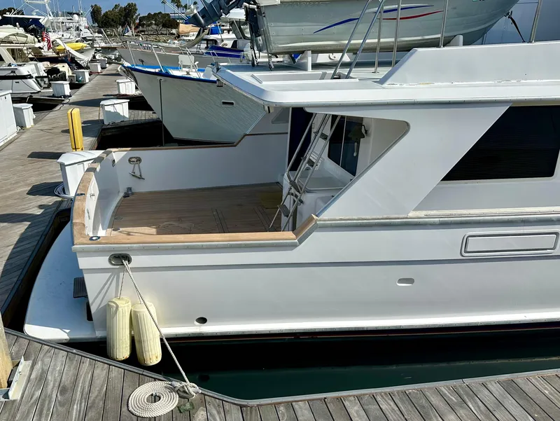 Slide: The Image of 1987 Tollycraft Pilothouse Motor Yacht docked at marina, side view. - 31