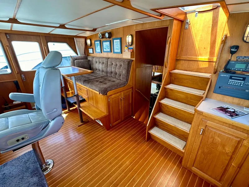 Slide: The Image of 1987 Tollycraft Pilothouse Motor Yacht interior with wood finish, seating, and navigation equipment. - 4