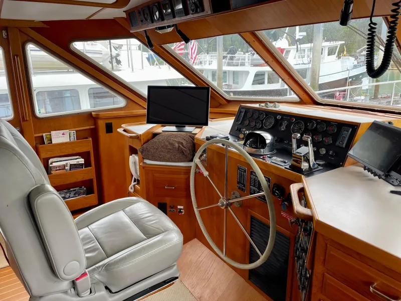 Slide: The Image of 1987 Tollycraft Pilothouse Motor Yacht interior with helm, steering wheel, and navigation equipment. - 6