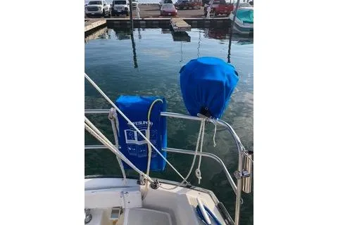 Slide: The Image of 1985 Tartan 28 Piper sailboat docked, featuring blue covers and marina view. - 15