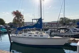 Slide: The Image of 1985 Tartan 28 Piper sailboat docked in a marina under clear skies. - 17