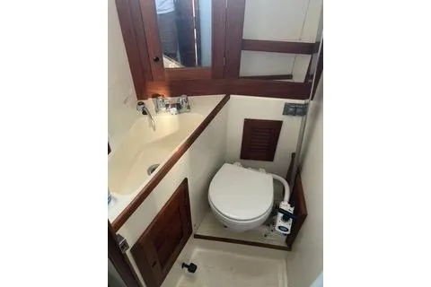 Slide: The Image of 1985 Tartan 28 Piper yacht bathroom with wooden accents and compact design. - 5