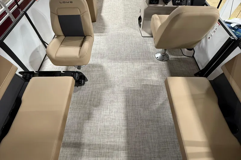 Slide: The Image of Interior of a 2026 Lowe LS 210 boat with beige seating and carpeted floor. - 10