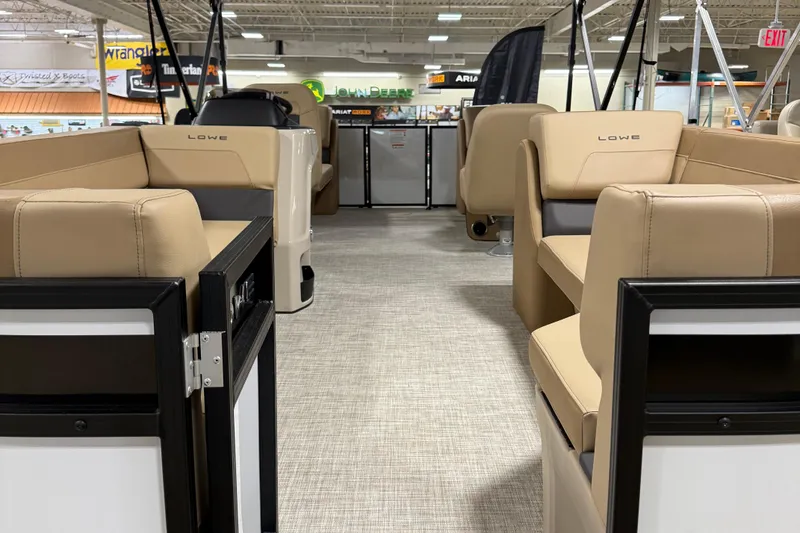 Slide: The Image of Interior view of 2026 Lowe LS 210 boat with beige seating and modern design. - 4