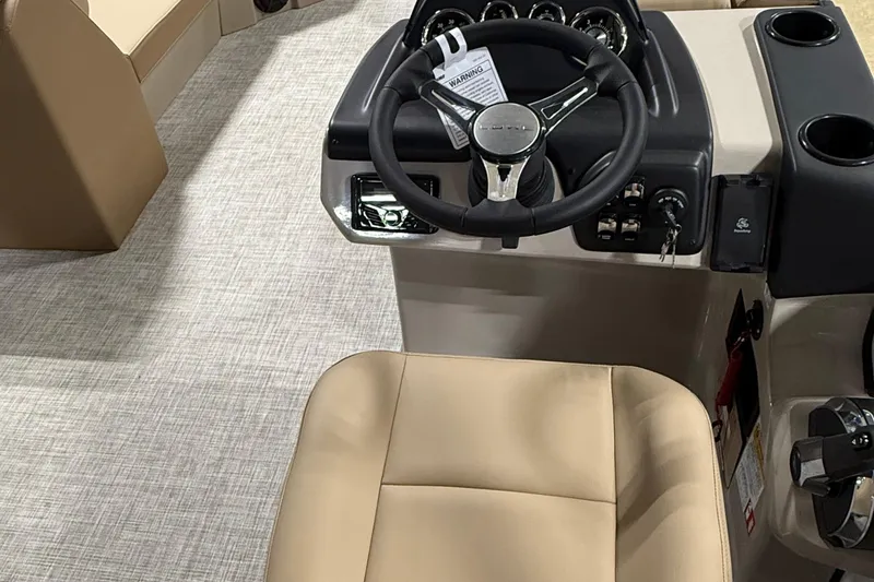 Slide: The Image of 2026 Lowe LS 210 boat interior with steering wheel and beige seating. - 8