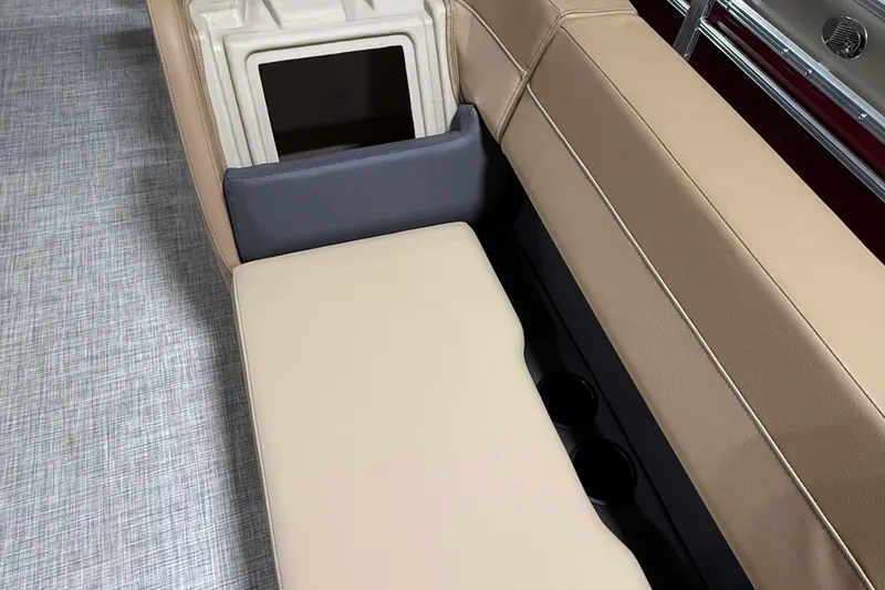 Slide: The Image of 2026 Lowe LS 210 boat interior with beige seating and integrated storage compartment. - 9