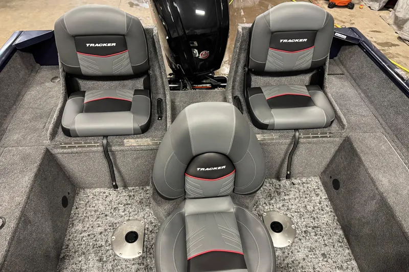 Slide: The Image of 2025 Tracker Pro Guide V-175 Combo boat interior with three gray seats and carpeted flooring. - 11